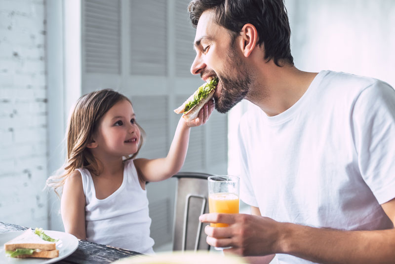 dad being fed by daughter