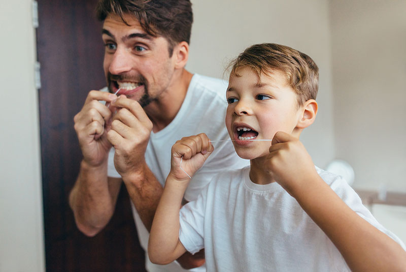 dad son flossing mirror