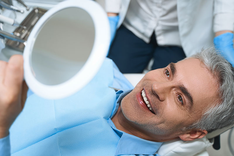 man smiling dentures